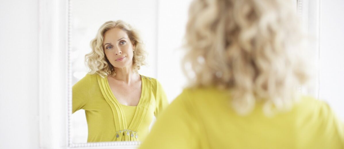 woman looking in the mirror